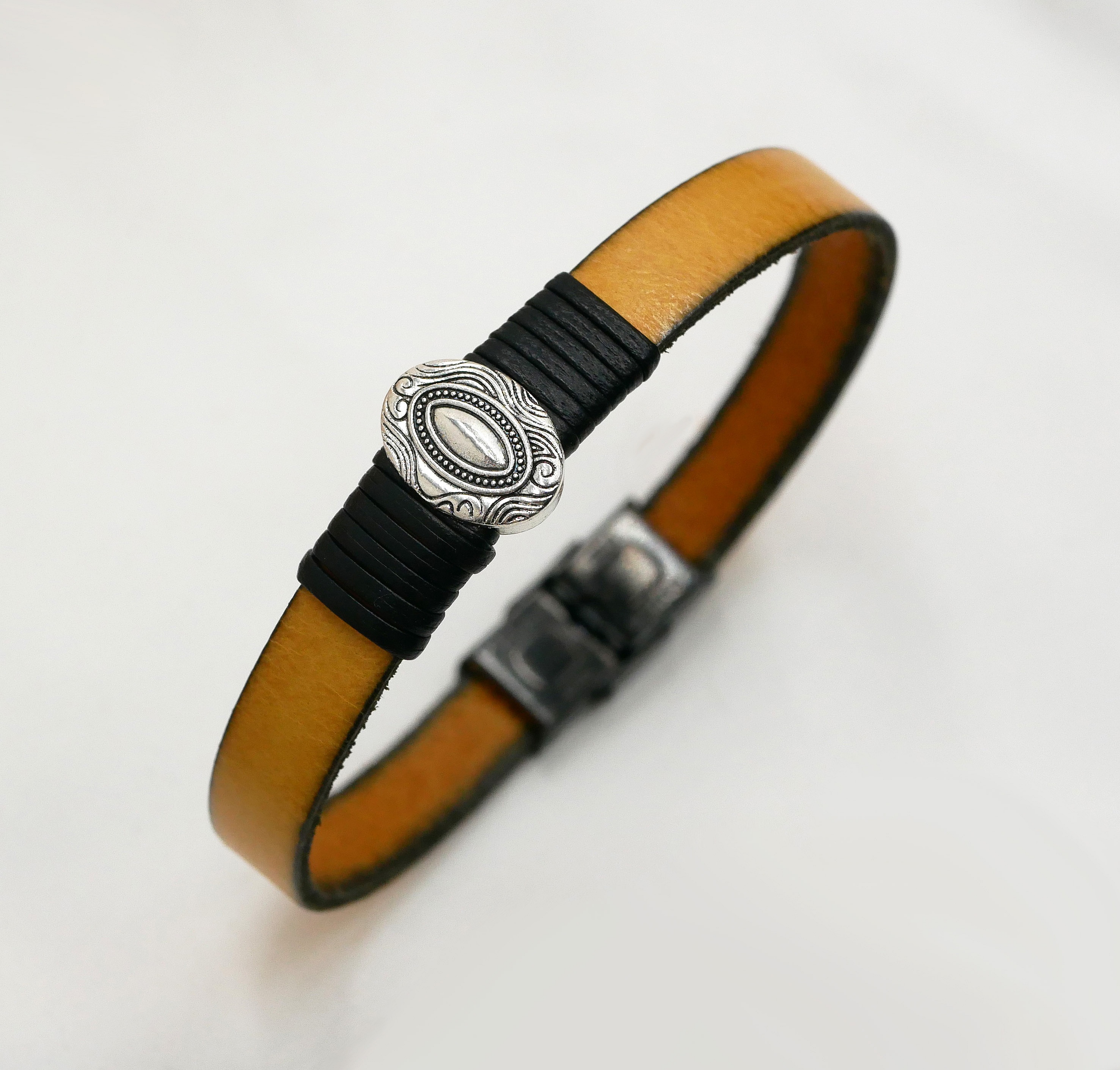 Tilpassbar l&aelig;rreim med sentralt, ovalt ornament innrammet av fine l&aelig;rstykker 