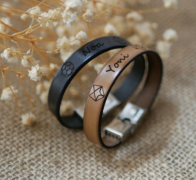 Personlig l&aelig;rarmb&aring;nd for barn inngravert med fornavn innrammet med tegninger etter eget valg