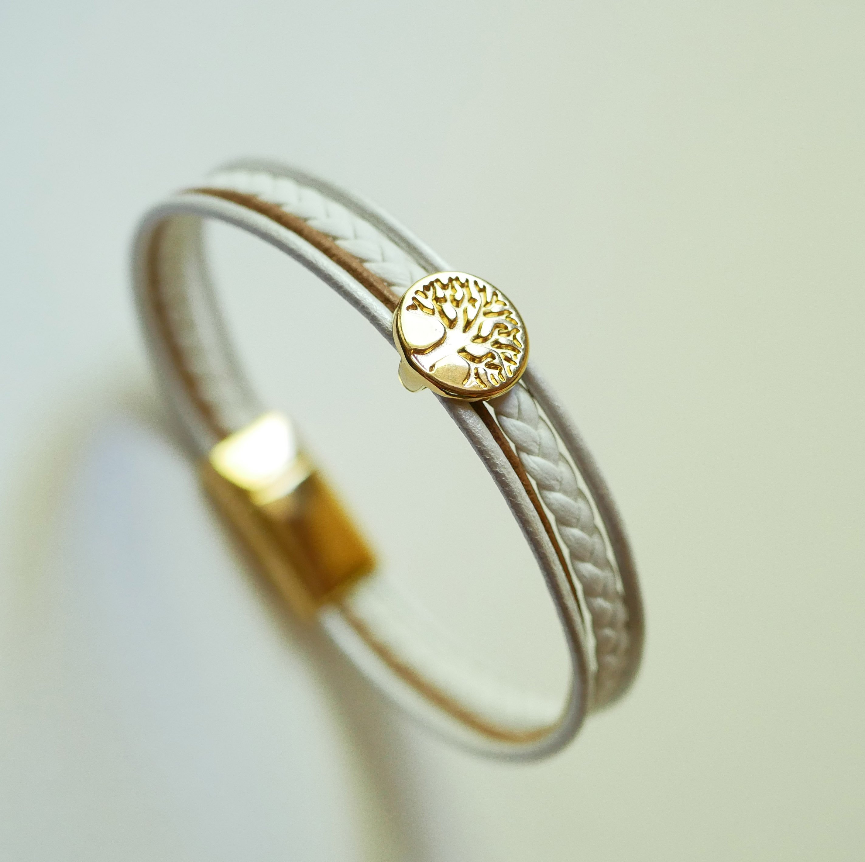 Mansjettarmbånd i hvitt og gull med cabochon av livets tre