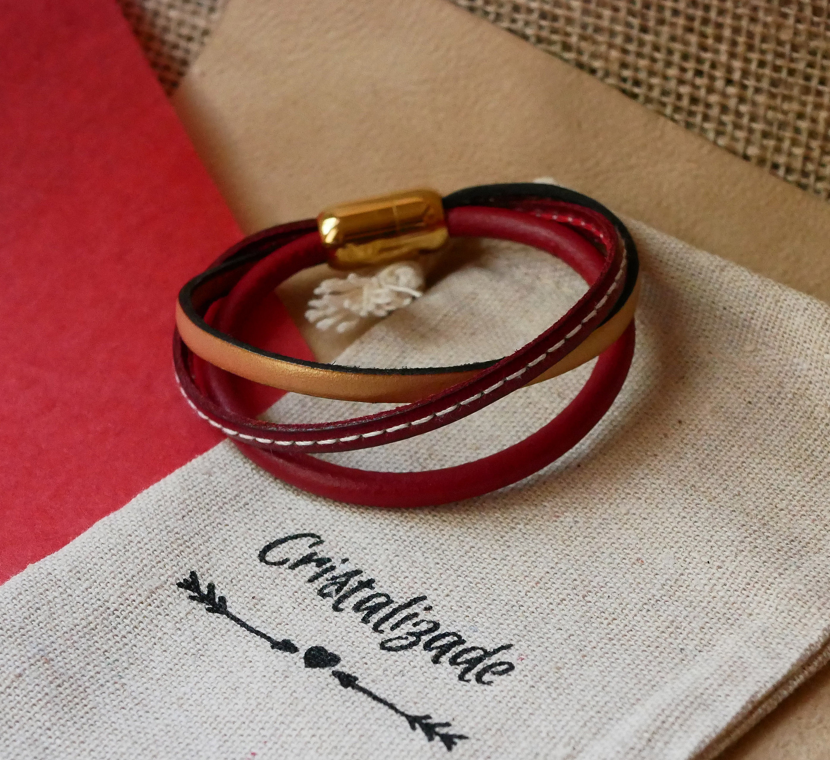 Mansjettarmb&aring;nd i r&oslash;dt og gull i flere skinntyper for kvinner