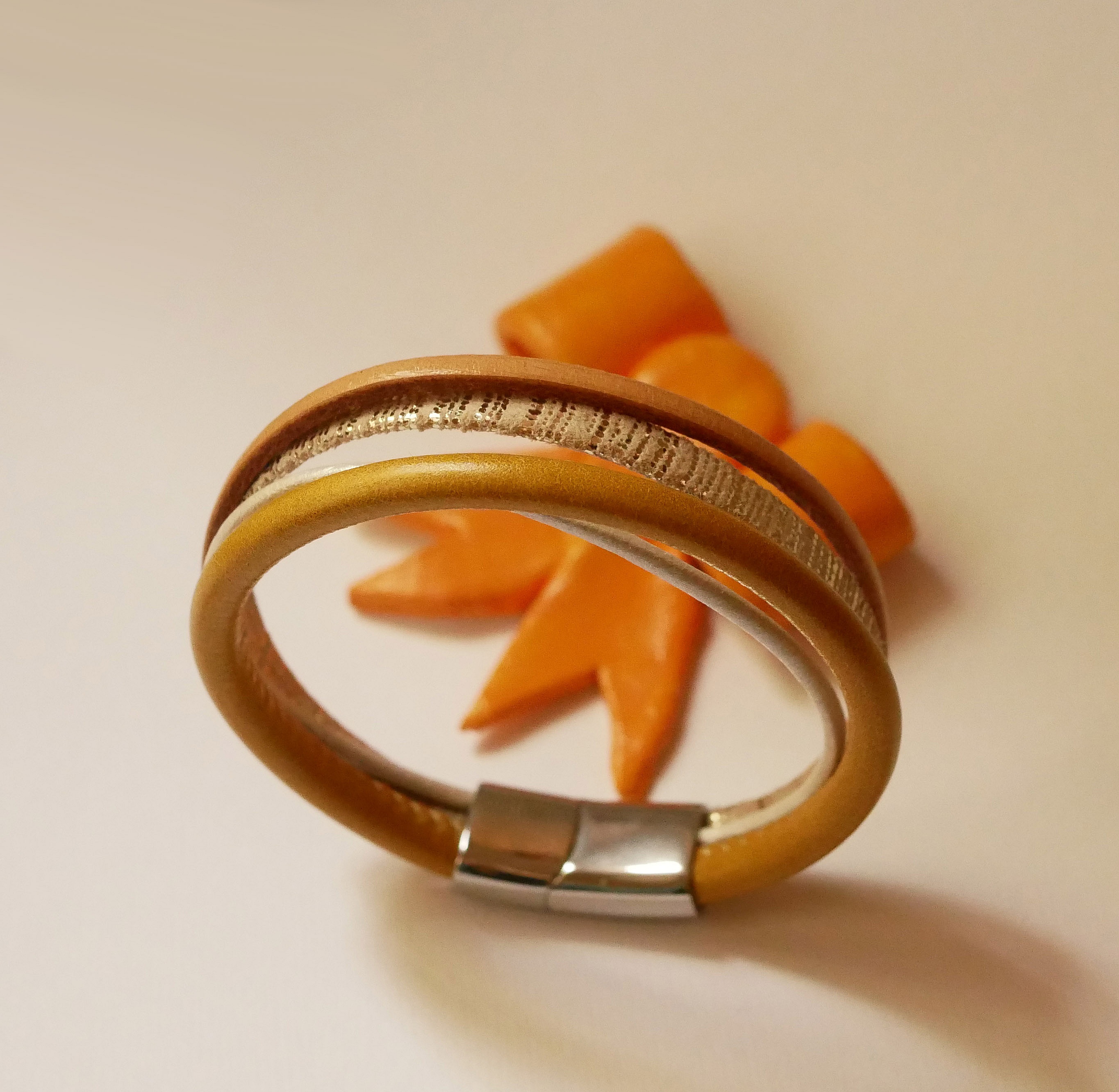 Mansjettarmb&aring;nd i beige og gull i flere skinntyper